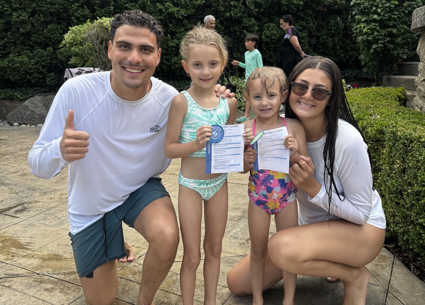Two swimmers celebrating their progress with Ilios instructors
